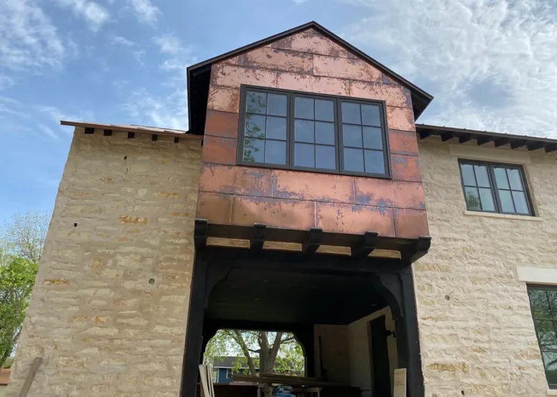 Copper metal panel facade on a stone building for Skylight Installation in Pierre