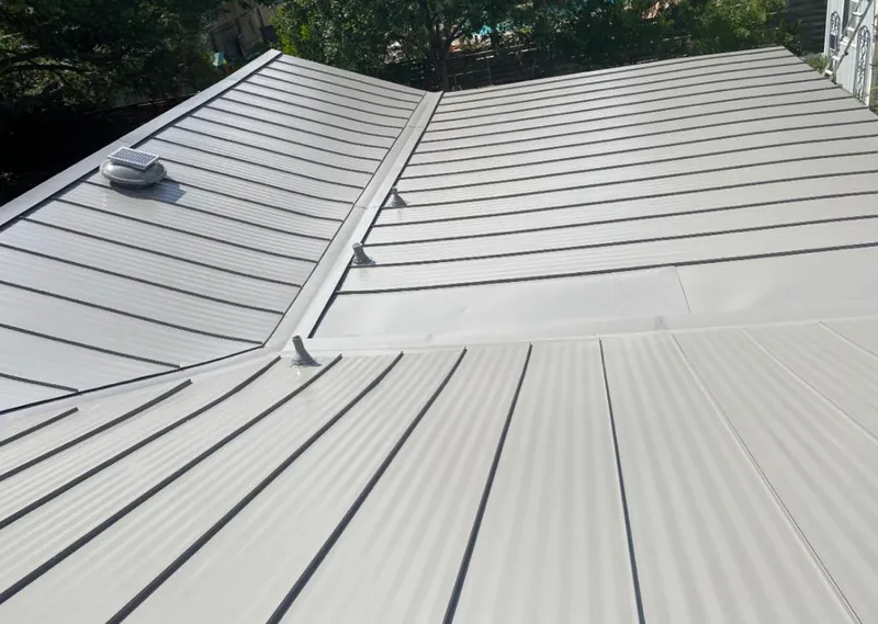 Solar attic fan installed on a metal roof for Roof Ventilation in Pierre